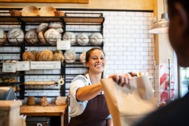 a woman serving a customer in a cafe